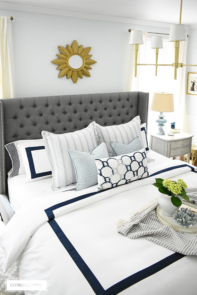 Adding summer touches to your bedroom is as simple as throw pillows, a casual throw, and some pretty coastal accents. Bring in the season with these these no-fail tips for a relaxing and airy summer bedroom!