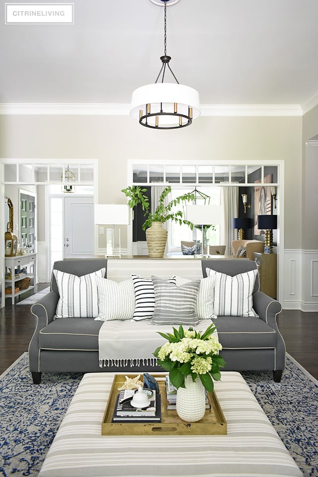 Create a casual and elegant summer living room with calming neutrals, layers of textures and hints on blue and white for a relaxing, laid-back look.