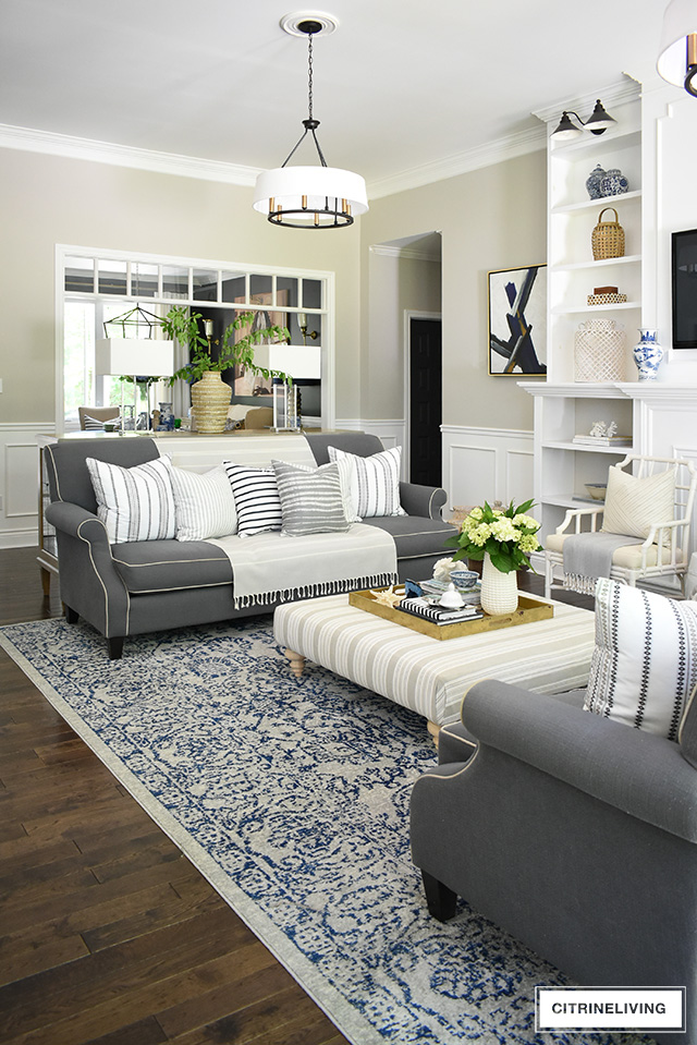 Create a casual and elegant summer living room with calming neutrals, layers of textures and hints on blue and white for a relaxing, laid-back look.