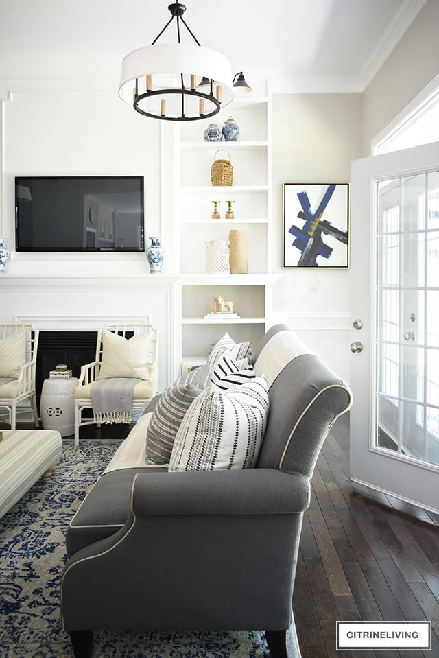 Create a casual and elegant summer living room with calming neutrals, layers of textures and hints on blue and white for a relaxing, laid-back look.