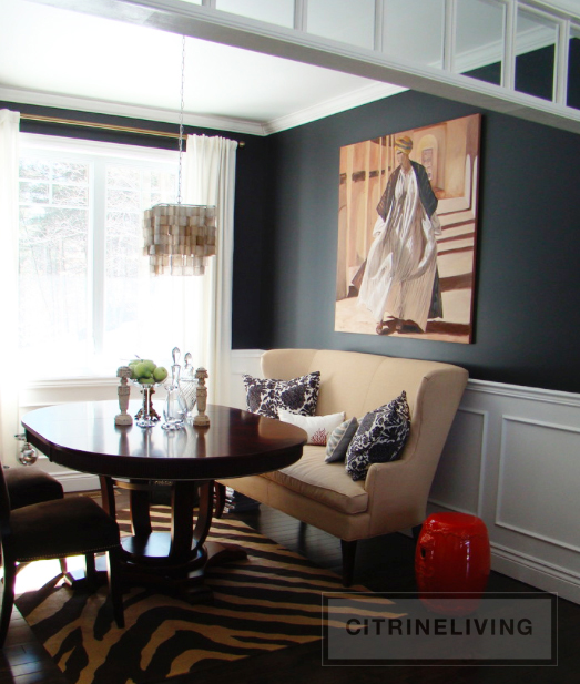 Dining room with black walls and white wainscotting.