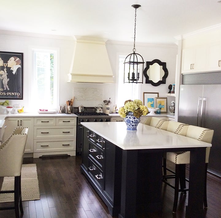 Traditional kitchen with no upper cabinets and black island.