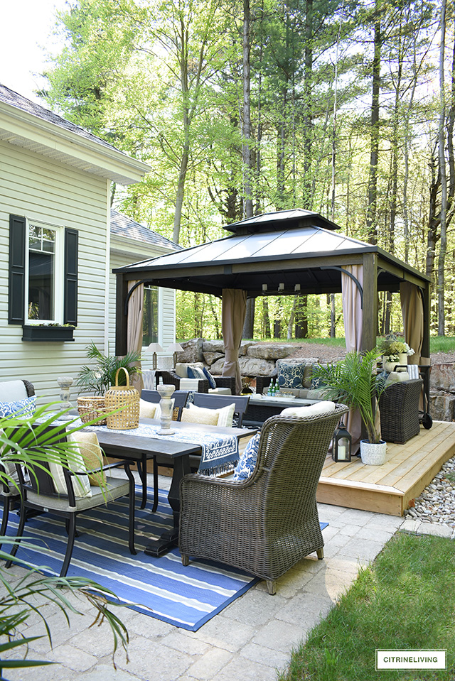 Outdoor patio makeover with large gazebo, dining area and lounge zone.