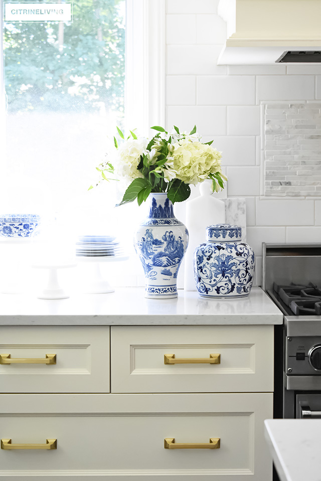 Collection of blue and white ginger jars, vases and dishes. Ivory drawers with brass hardware.