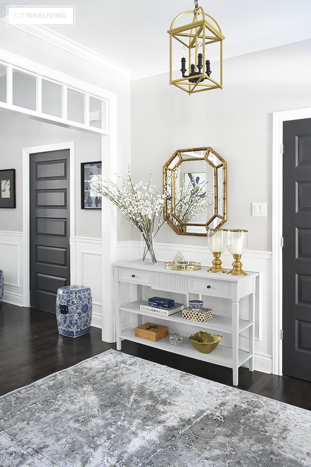 Favorite Makeovers - entryway makeover with light grey rug, chalk painted console table and brass bamboo mirror.
