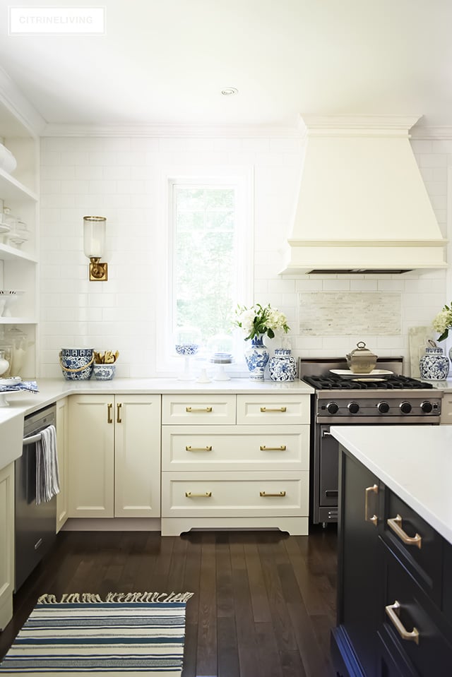 White kitchen, brass hardware pulls, custom range hood, styling ideas.