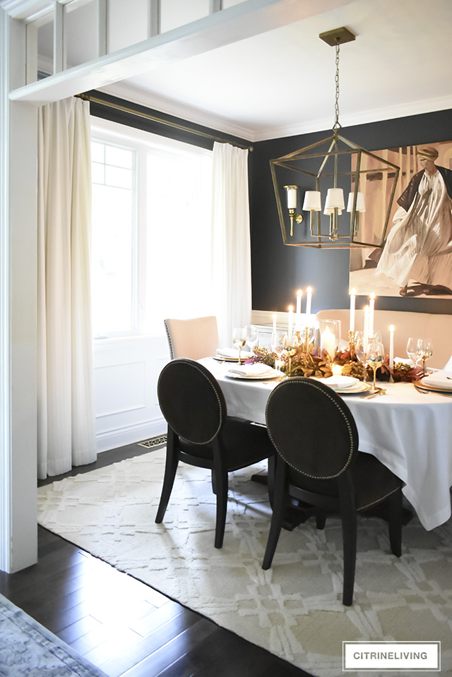 A white and gold Thanksgiving tablescape, with beautiful fall foliage in warm, earthy tones is a simple and elegant way to entertain for the holidays!