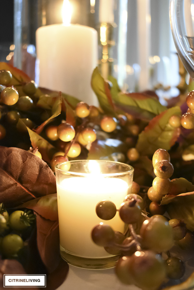 A white and gold Thanksgiving tablescape, with beautiful fall foliage in warm, earthy tones is a simple and elegant way to entertain for the holidays!