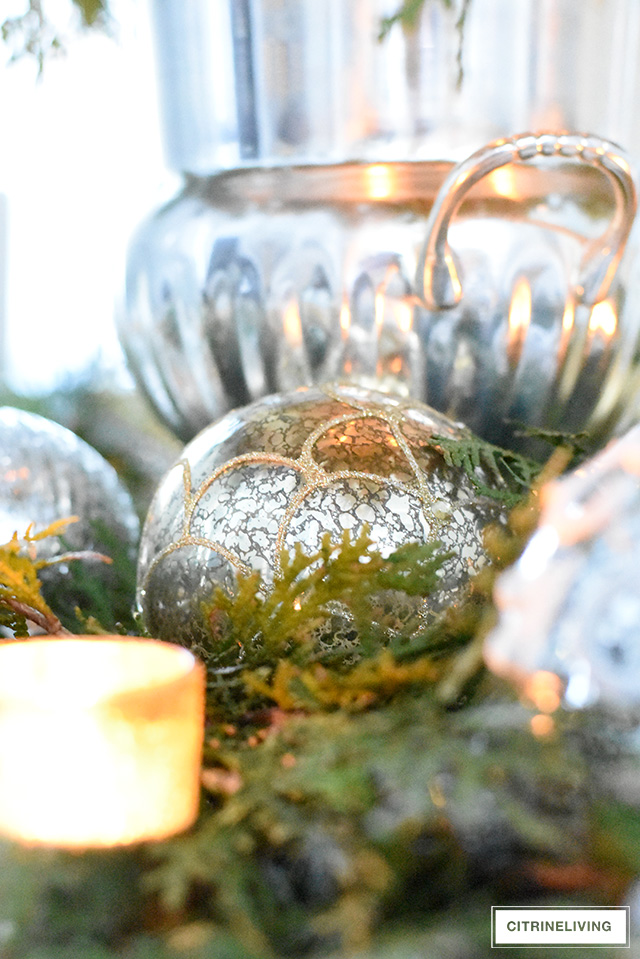 A Christmas table with fresh greenery and beautiful ornaments is easier to create than you think! It's simple, sophisticated, elegant and oh, so festive!