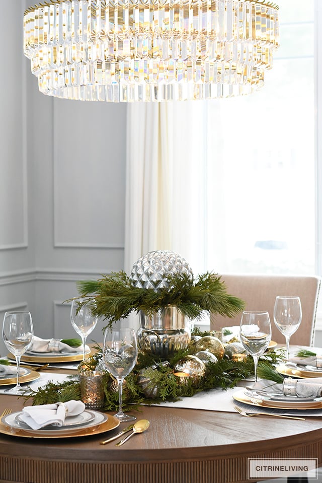 A Christmas table with fresh greenery and beautiful ornaments is easier to create than you think! It's simple, sophisticated, elegant and oh, so festive!