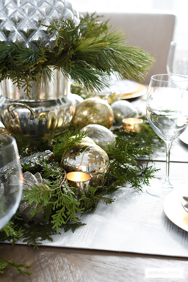 A Christmas table with fresh greenery and beautiful ornaments is easier to create than you think! It's simple, sophisticated, elegant and oh, so festive!