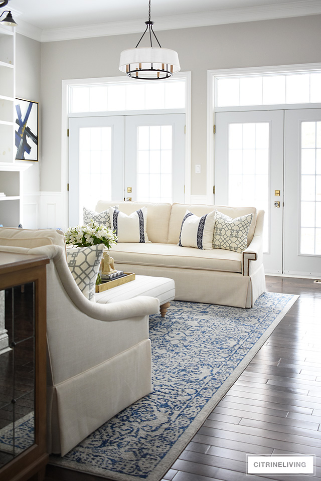 Gorgeous new white sofas completely transform this living room into a bright, airy and sophisticated space!