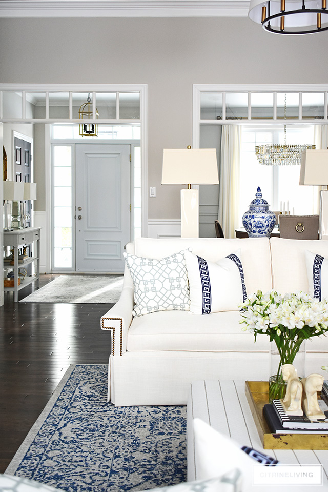 New white sofas completely transform this open concept living room to an airy, sophisticated space.