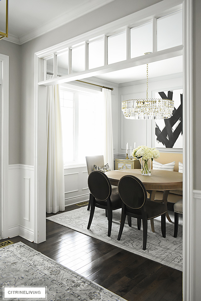 A gorgeous dining room makeover reveal with new gray walls and moldings, painted from the crown to the basboards for a chic, sophisticated, bright and airy look.
