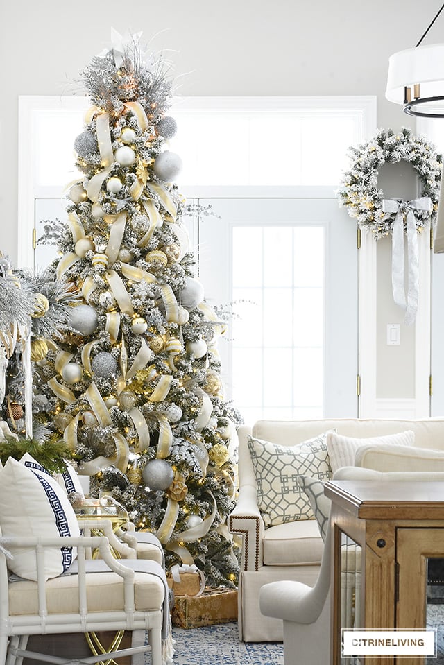 Gorgeous flocked Christmas tree + garland, dressed in magical silver and gold!