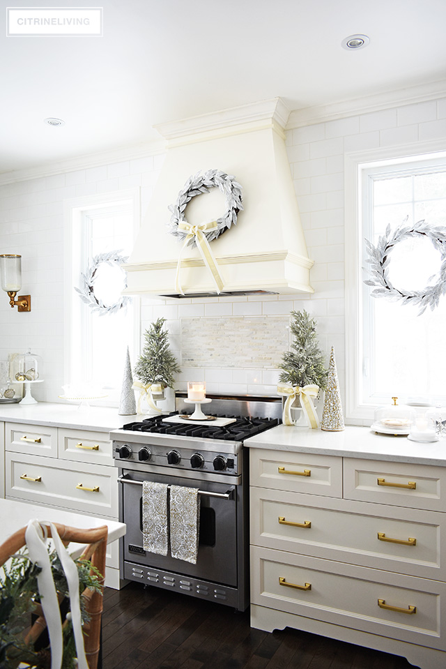 Christmas kitchen decorating using silver and gold mixed with touches of holiday greenery is the perfect mix of elegant and chic.