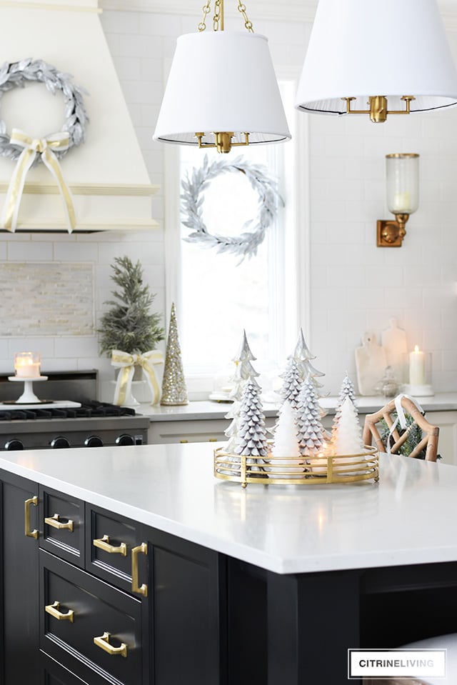 Christmas kitchen decorating using silver and gold mixed with touches of holiday greenery is the perfect mix of elegant and chic.