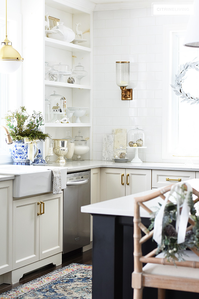 Christmas kitchen decorating using silver and gold mixed with touches of holiday greenery is the perfect mix of elegant and chic.