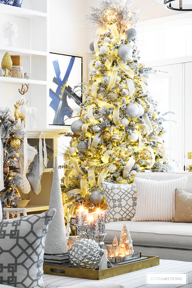 Gorgeous flocked Christmas tree + garland, dressed in magical silver and gold!