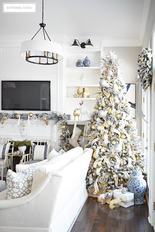 Gorgeous flocked Christmas tree + garland, dressed in magical silver and gold!