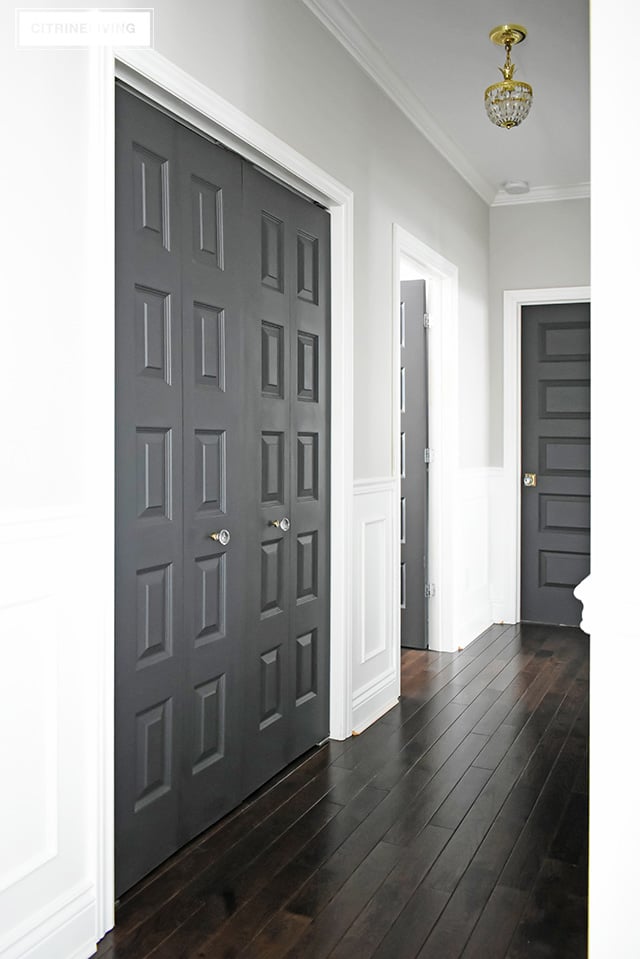 https://citrineliving.com/wp-content/uploads/2019/01/hallway-linen-closet-oak-hardwood-flooring-black-doors.jpg