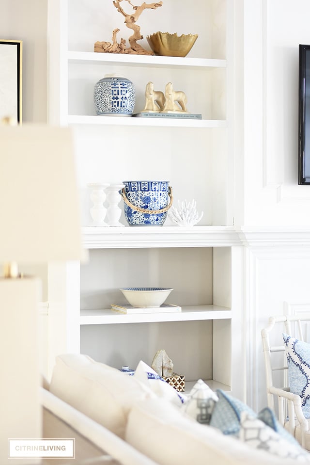 Beautiful and bright spring living room decorating in blue, white and brass plus our new gorgeous brass chandeiers and wall sconces!