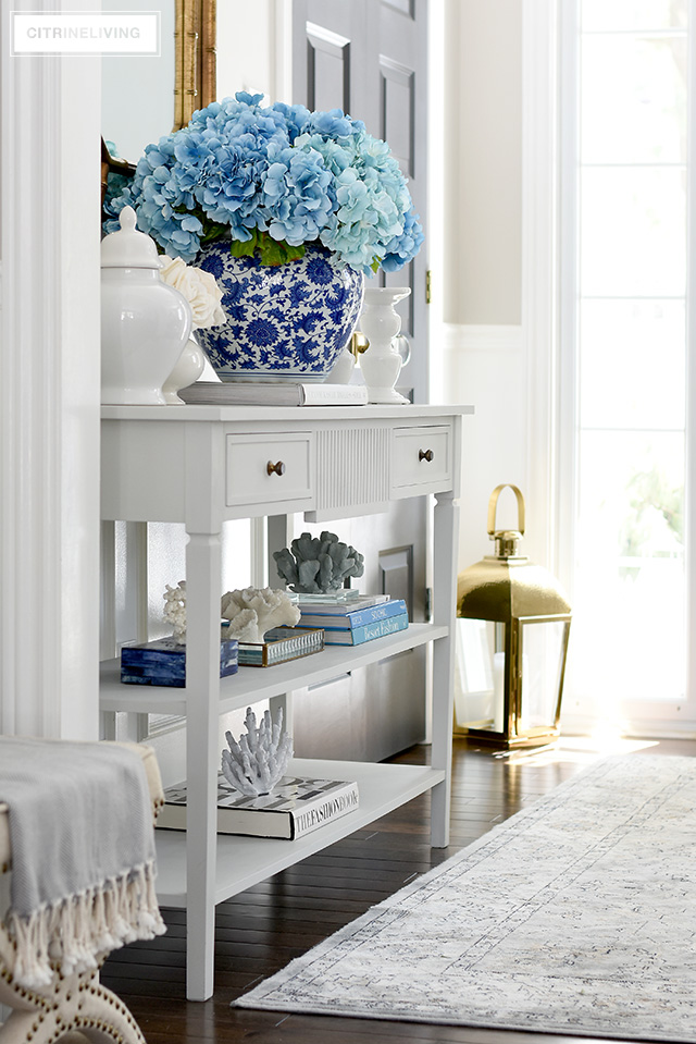 A gorgeous Spring entryway with blue, white and brass touches creates a fresh and vibrant welcome.