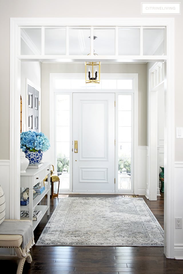 Welcoming entryway with blue, white and brass is fresh and beautiful for Spring!