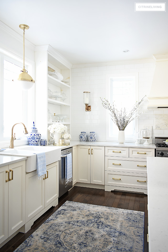 Spring decorating ideas - white kitchen with beautiful faux florals and blue and white touches.