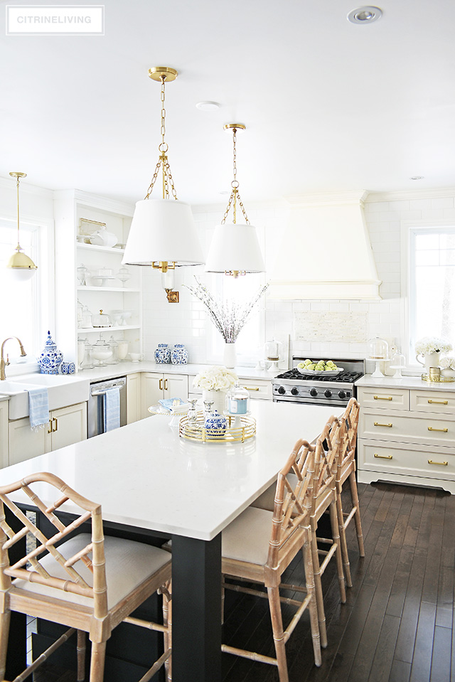 Spring kitchen decorating ideas - gorgeous white kitchen with blue and white accents, faux florals and light blue touches.