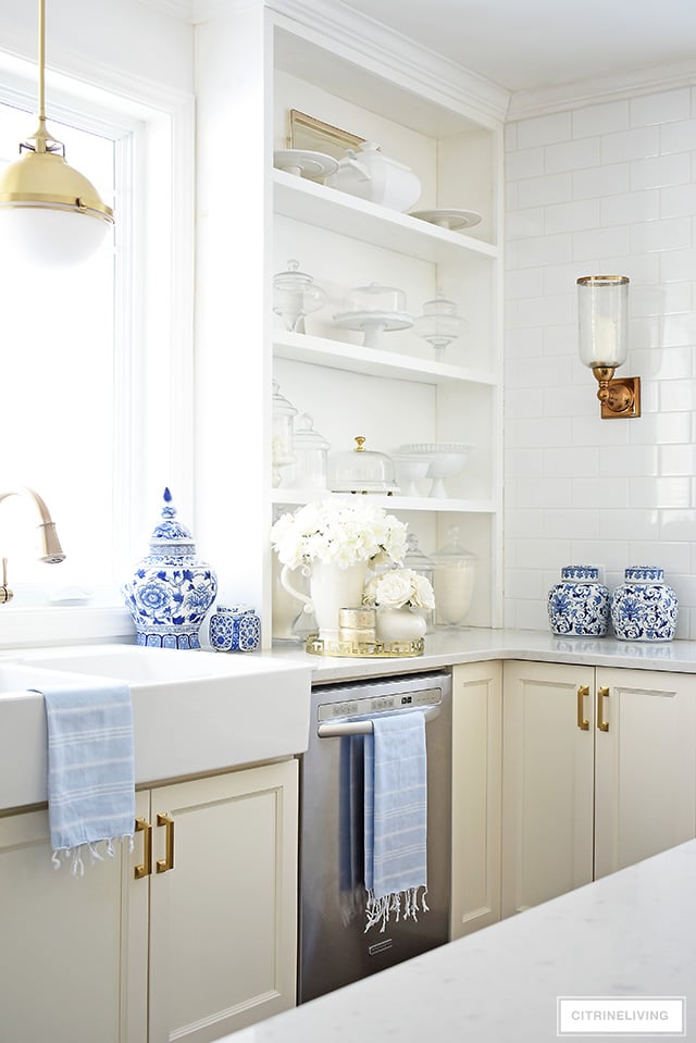 Spring decorating ideas - white kitchen with beautiful faux florals and blue and white touches.