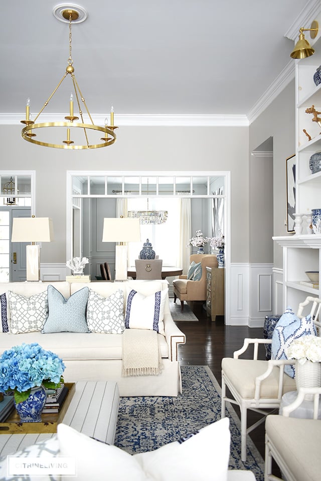 Beautiful and bright spring living room decorating in blue, white and brass plus our new gorgeous brass chandeiers and wall sconces!