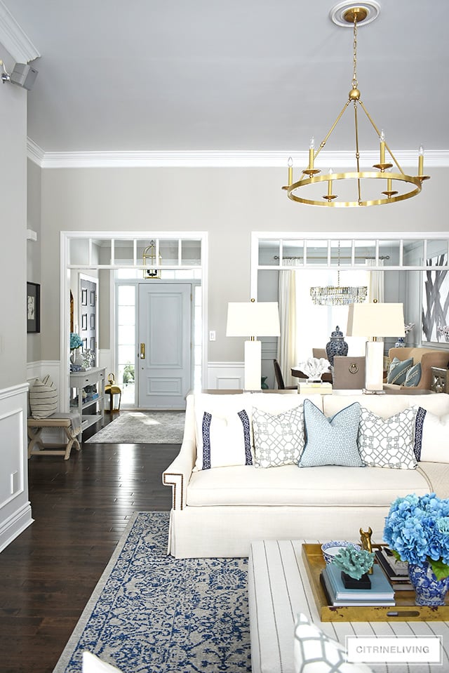 Beautiful and bright spring living room decorating in blue, white and brass plus our new gorgeous brass chandeiers and wall sconces!