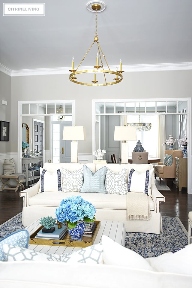 Beautiful and bright spring living room decorating in blue, white and brass plus our new gorgeous brass chandeiers and wall sconces!