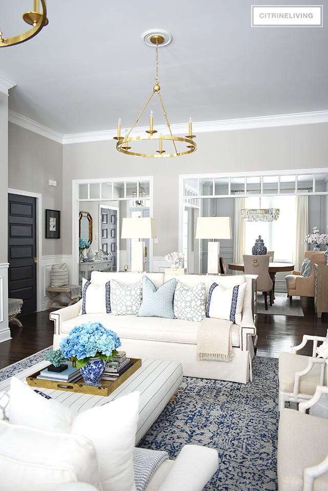 Beautiful and bright spring living room decorating in blue, white and brass plus our new gorgeous brass chandeiers and wall sconces!