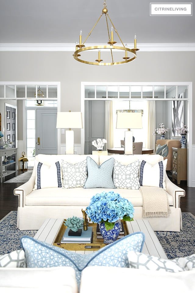 Beautiful and bright spring living room decorating in blue, white and brass plus our new gorgeous brass chandeiers and wall sconces!