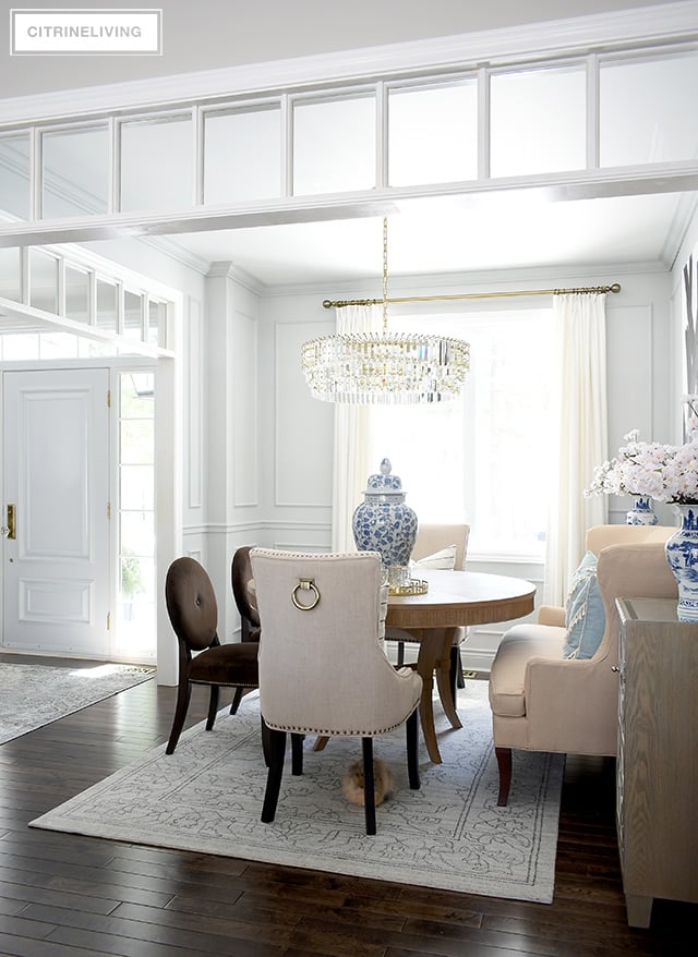 Simple spring dining room decorating using blue and white ginger jars, vases, faux cherry blossoms and light blue accessories.