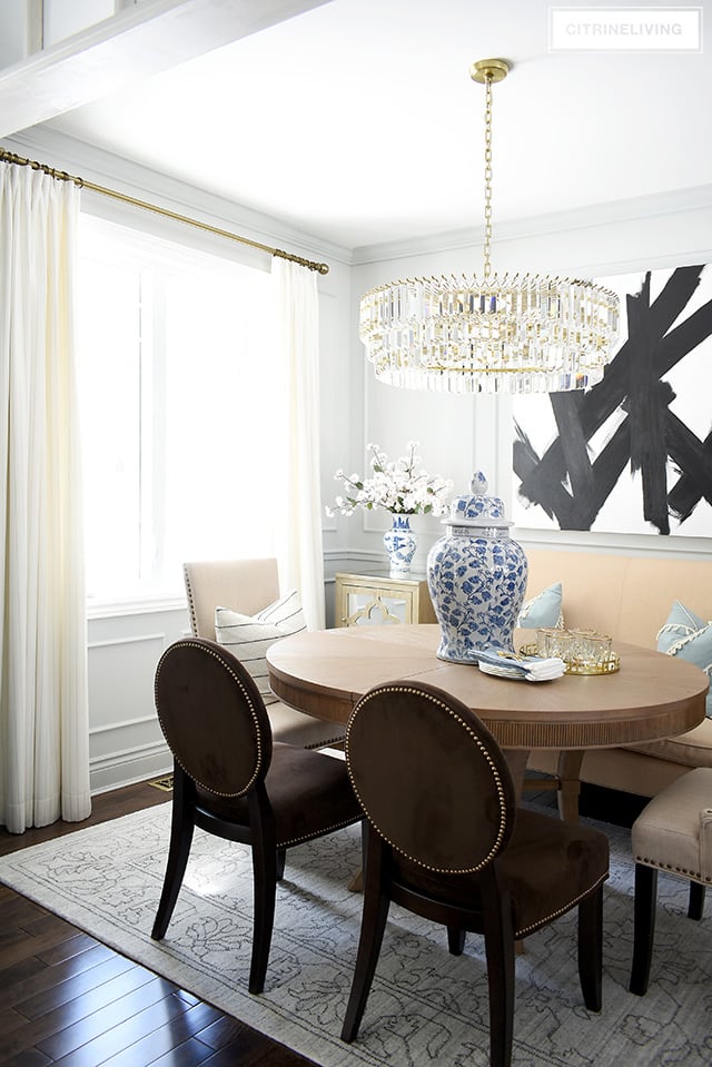 Dining room with spring touches - blue and white jars and vases with some faux cherry blossoms.