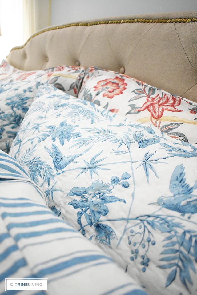 Gorgeous linen and quilted bedding with mixed prints, blue and white stripes and florals with mixed with red florals.