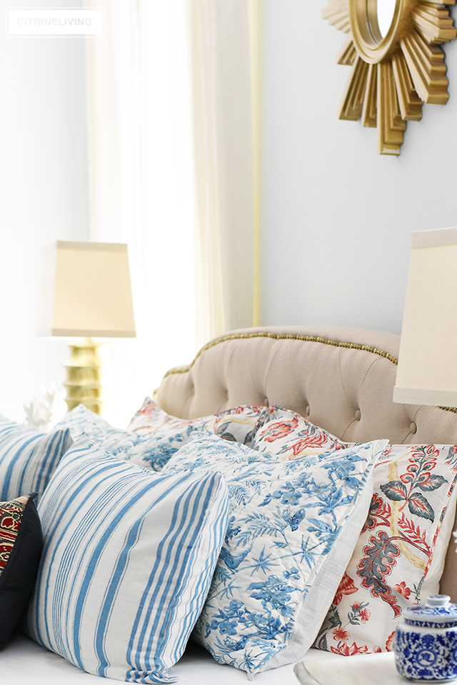 Gorgeous linen and quilted bedding with mixed prints, blue and white stripes and florals with mixed with red florals.