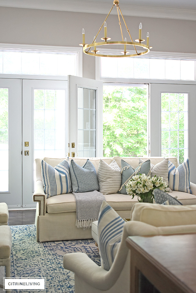 Elegant living room decorated for summer using a soft and beautiful light blue, white, cream and ivory color palette.