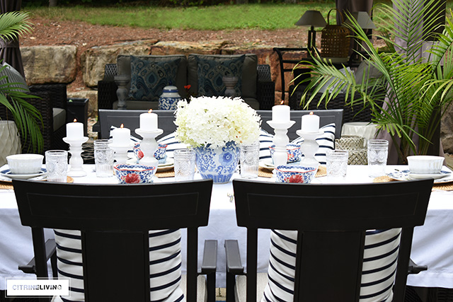 Outdoor late summer tablescape with vintage inspired dishes and blue and white.
