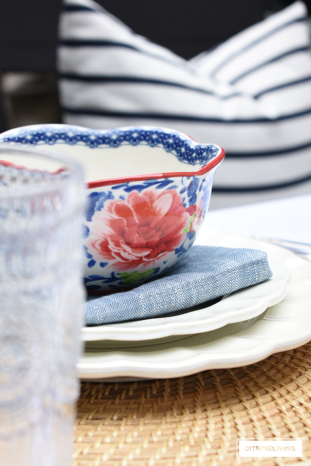 Vintage inspired outdoor late summer tablescape with white scalloped dishes and blue and white bowls.