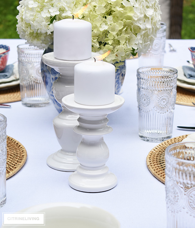 Vintage inspired outdoor late summer tablescape with white pillar candleholders.
