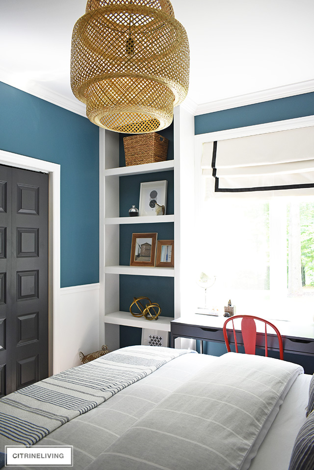 Modern coastal teen bedroom - open shelves with modern accessories - woven baskets., wood frames, modern art and objects.