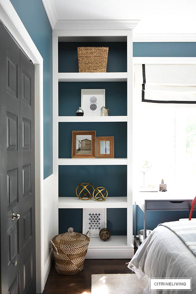 Modern coastal teen bedroom - open shelves with modern accessories - woven baskets., wood frames, modern art and objects.