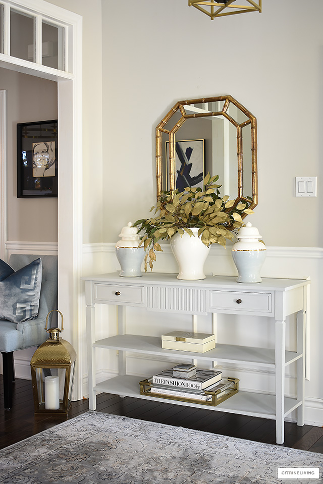 Fall entryway decorating - simple console table styling with ginger jars, faux gold leaves, design books and decorative box.