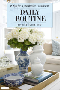 Beautiful blue and white vase with faux white floral arrangement paired with pale blue ginger jars.