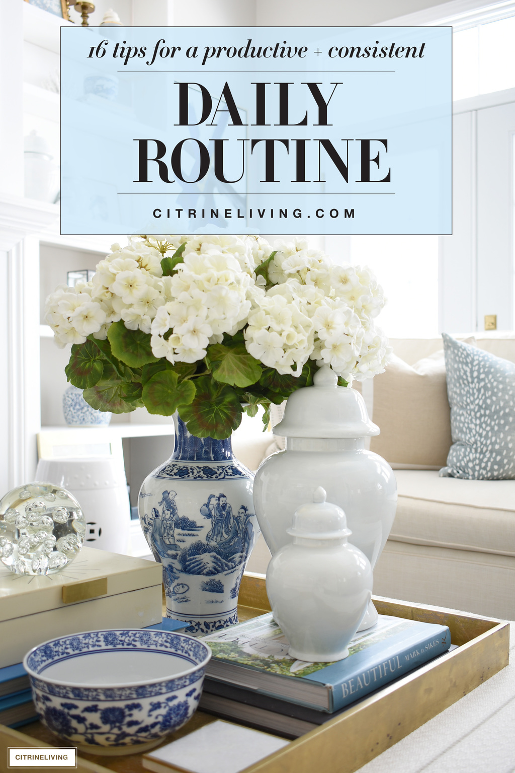 Beautiful blue and white vase with faux white floral arrangement paired with pale blue ginger jars.
