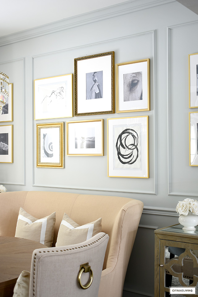 Inexpensive DIY gallery wall using a mix of gold frames, black and white photography and art.